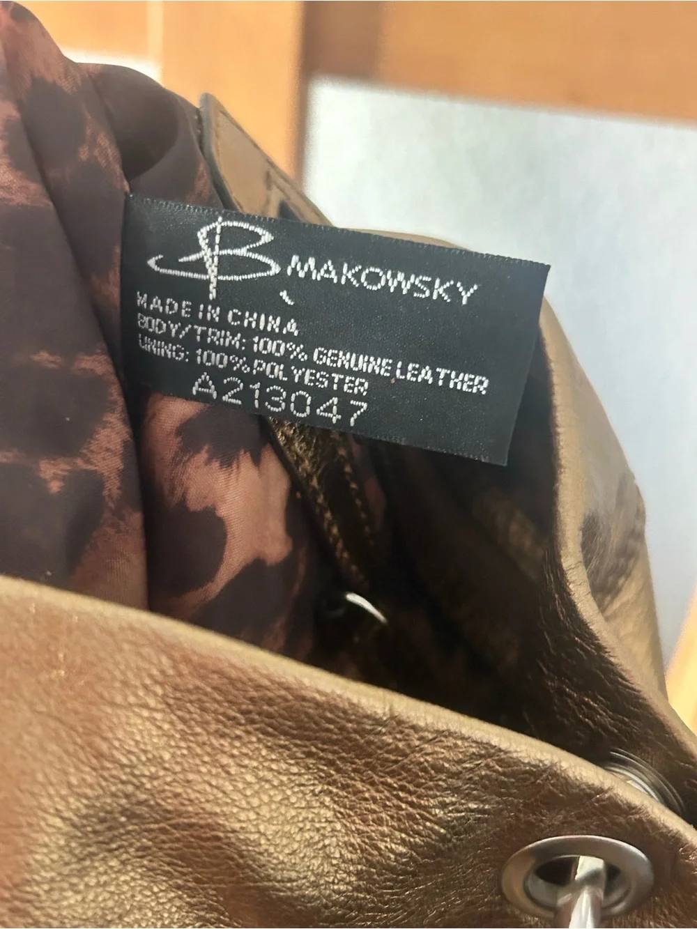 b. makowsky Metallic Gold Crossbody with Tassel Accent